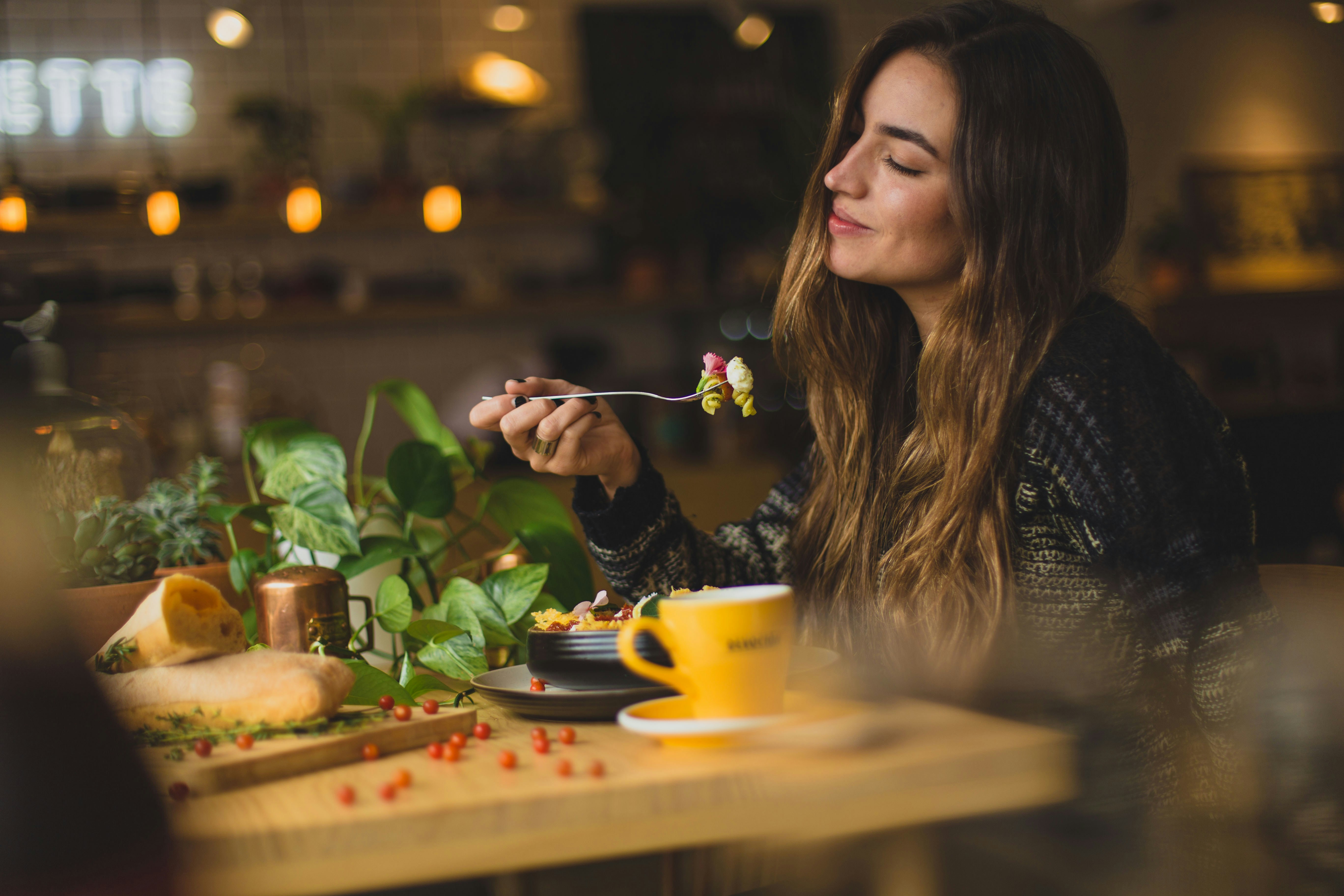 A woman enjoying a meal at a restaurant